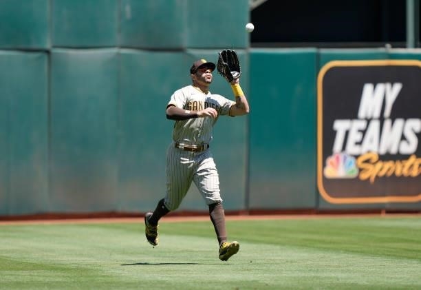 Tommy Pham of the San Diego Padres catches a fly ball off the bat of Elvis Andrus of the Oakland Athletics in the bottom of the second inning at...