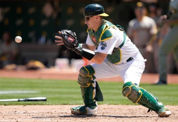 Sean Murphy of the Oakland Athletics takes the throw at home plate against the San Diego Padres in the top of the fourth inning at RingCentral...