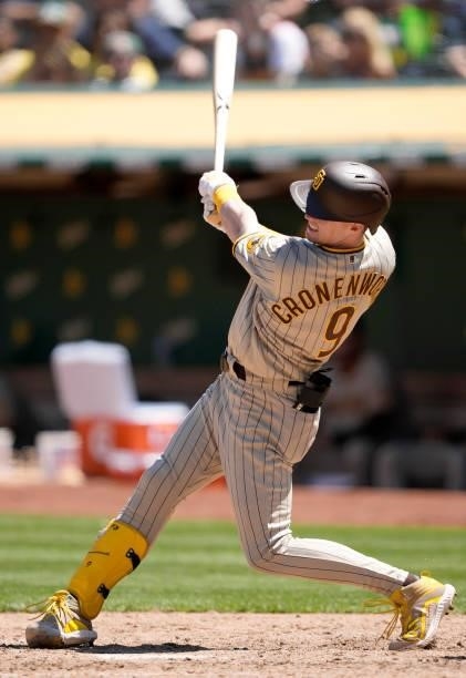 Jake Cronenworth of the San Diego Padres bats against the Oakland Athletics in the top of the six inning at RingCentral Coliseum on August 04, 2021...
