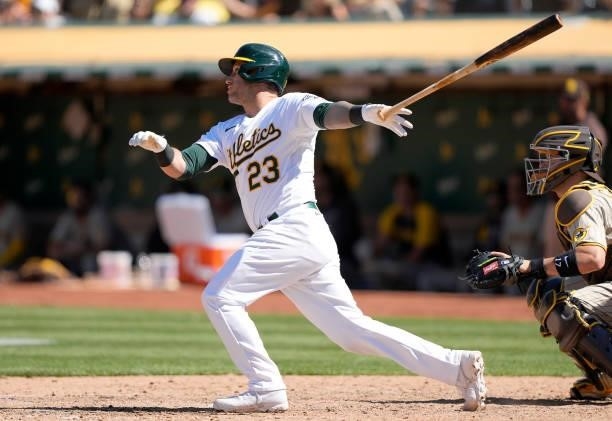 Yan Gomes of the Oakland Athletics hits a pinch hit RBI single scoring Tony Kemp against the San Diego Padres in the bottom of the ninth inning at...