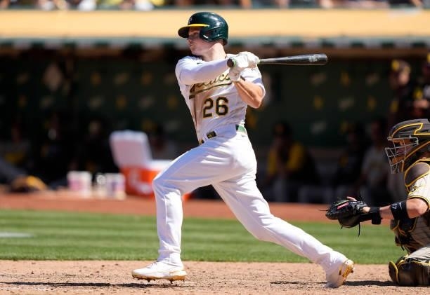 Matt Chapman of the Oakland Athletics hits an RBI single scoring Ramon Laureano against the San Diego Padres in the bottom of the ninth inning at...