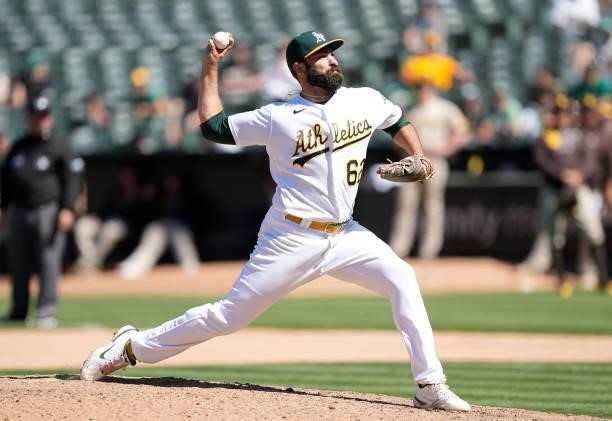 Lou Trivino of the Oakland Athletics pitches against the San Diego Padres in the top of the tenth inning at RingCentral Coliseum on August 04, 2021...