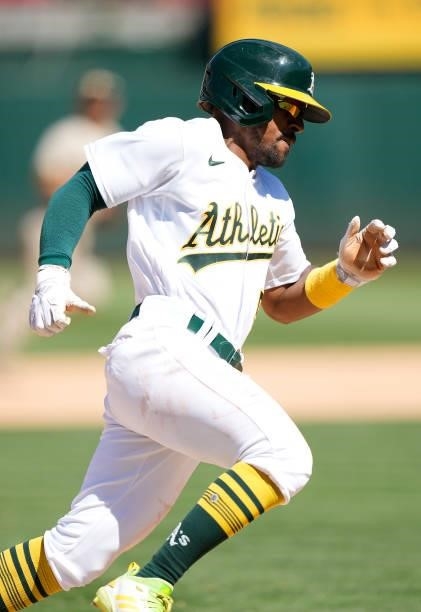 Tony Kemp of the Oakland Athletics rounds third base to score against the San Diego Padres in the bottom of the ninth inning at RingCentral Coliseum...
