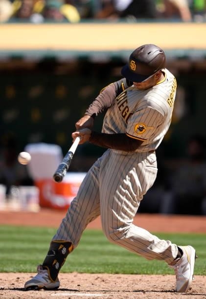 Trent Grisham of the San Diego Padres bats against the Oakland Athletics in the top of the ninth inning at RingCentral Coliseum on August 04, 2021 in...