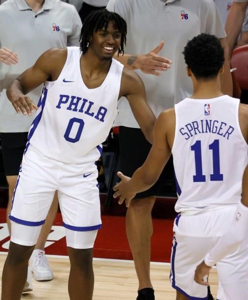 Tyrese Maxey of the Philadelphia 76ers greets teammate Jaden Springer on the court during a timeout in their game against the Dallas Mavericks during...