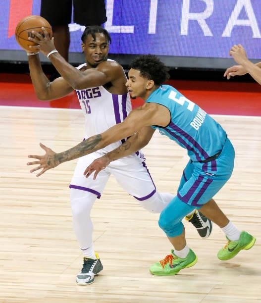 Davion Mitchell of the Sacramento Kings looks to pass against James Bouknight of the Charlotte Hornets during the 2021 NBA Summer League at the...