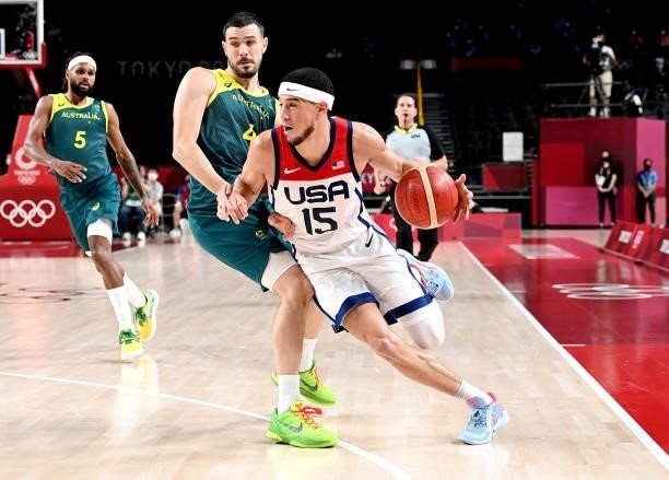 Devin Booker of the USA breaks away from the defence of Chris Goulding of Australia during the Basketball semi final match between Australia and the...
