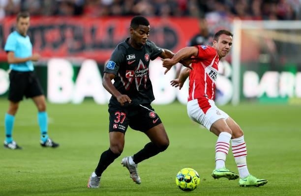 Raphael Nwadike of FC Midtjylland challenges Mario Götze of PSV Eindhoven during the UEFA Champions League third qualifying round second leg between...