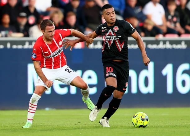 Evander of FC Midtjylland challenges Mario Götze of PSV Eindhoven during the UEFA Champions League third qualifying round second leg between FC...