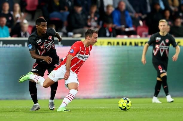 Raphael Nwadike of FC Midtjylland challenges Mario Götze of PSV Eindhoven during the UEFA Champions League third qualifying round second leg between...