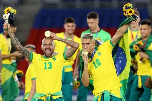 Richarlison of Team Brazil celebrates their side's victory with Dani Alves of Brazil after the Men's Gold Medal Match between Brazil and Spain on day...