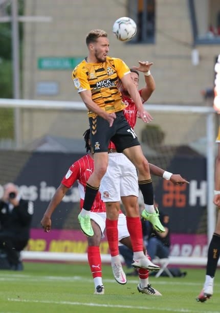 Sam Smith of Cambridge United rises to head the ball during the Carabao Cup 1st Round match between Cambridge United and Swindon Town at Abbey...