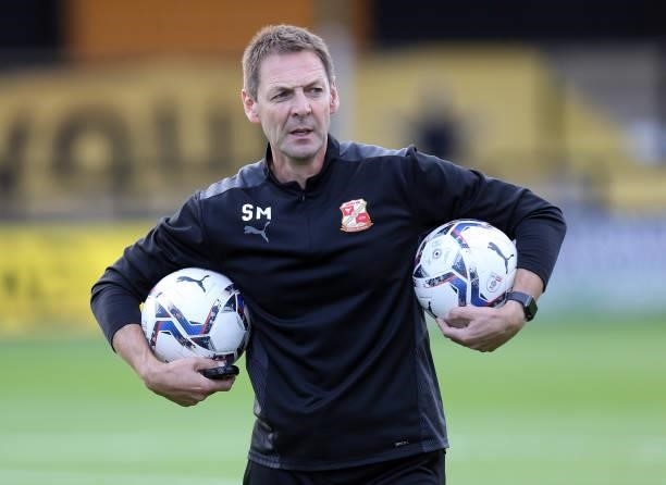 Swindon Town assistant coach Scott Marshall during the pre match warm up prior to the Carabao Cup 1st Round match between Cambridge United and...