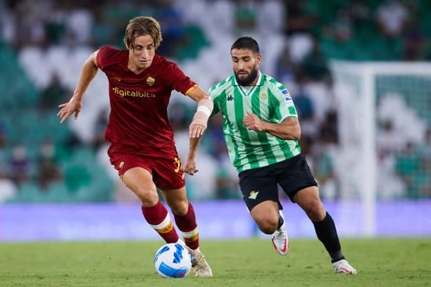 Nabil Fekir of Real Betis competes for the ball with Edoardo Bove of AS Roma during a friendly match between Real Betis and AS Roma at Estadio Benito...