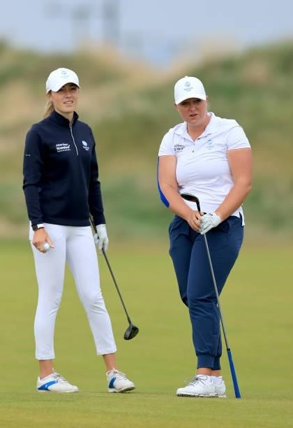 Chloe Goadby of Scotland plays a shot watched by Hazel MacGarvie during the pro-am as a preview for the Trust Golf Women's Scottish Open at Dumbarnie...