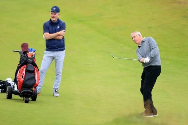 Ricky Hall of Scotland The Director of Golf at The Trump Turnberry Resort plays a shot watched by Alan Hogg of Scotland the Chief Executive of...