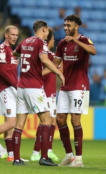 Kion Etete of Northampton Town celebrates victory at the end of the game with team mate Sid Nelson during the Carabao Cup 1st round match between...