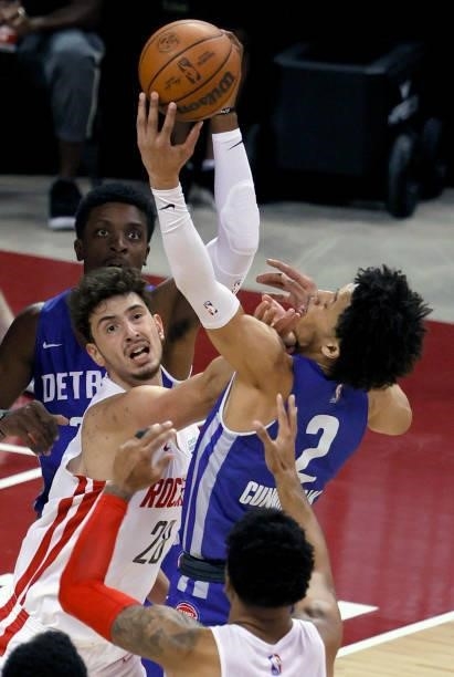 Alperen Sengun of the Houston Rockets and Cade Cunningham of the Detroit Pistons fight for a rebound during the 2021 NBA Summer League at the Thomas...