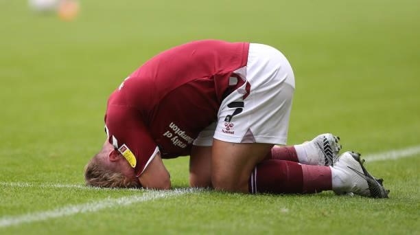 Sam Hoskins of Northampton Town lays injured during the Carabao Cup 1st round match between Coventry City and Northampton Town at The Coventry...