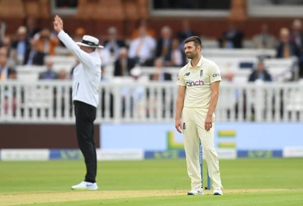 Mark Wood of England reacts after being his for a six by Rohit Sharma of India during the 2nd LV= Test match between England and India at Lord's...