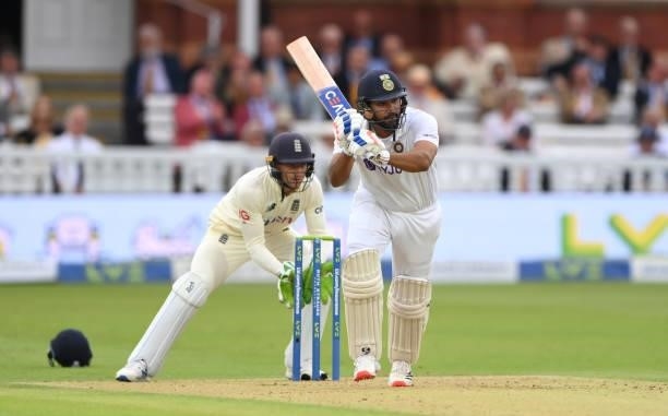 India batsman Rohit Sharma hits a ball from Moeen Ali towards the boundary watched by Jos Buttler during day one of the Second Test Match between...