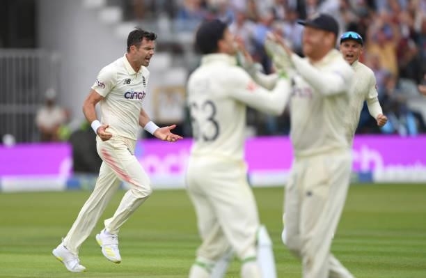 England bowler James Anderson celebrates after dismissing Pujara as Jos Buttler congratulates catcher Jonny Bairstow during day one of the Second...