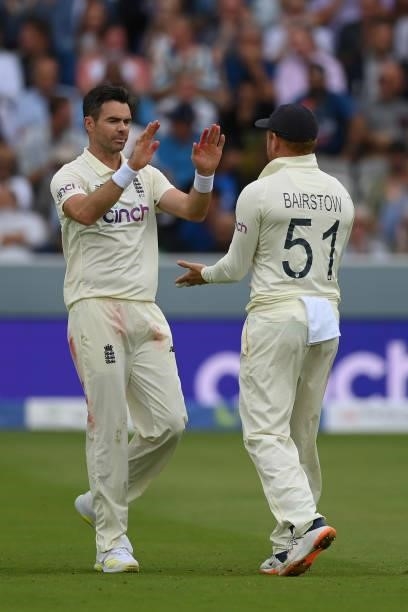 Jimmy Anderson of England celebrates with Jonny Bairstow after dismissing Cheteshwar Pujara of India of India during the Second LV= Insurance Test...