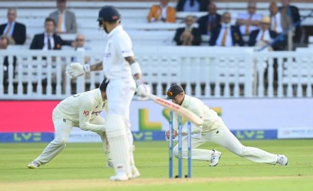 Joe Root of England catches Virat Kohli of India during the 2nd LV= Test match between England and India at Lord's Cricket Ground on August 12, 2021...
