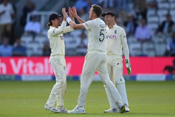 Ollie Robinson of England celebrates with Rory Burns and Jos Buttler after dismissing Virat Kohli of India during the Second LV= Insurance Test...