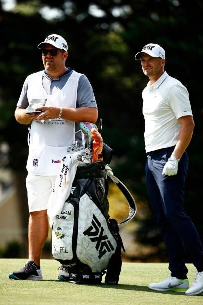 Wyndham Clark of the United States waits alongside his caddie before hitting his second shot on the 13th hole during the first round of the Wyndham...