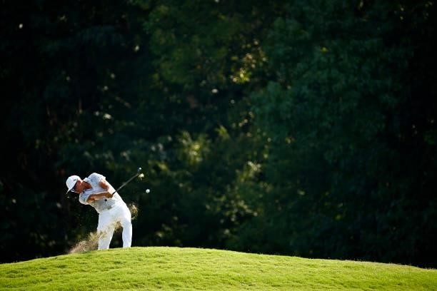 Rickie Fowler of the United States plays an approach shot from the rough on the 14th hole during the first round of the Wyndham Championship at...
