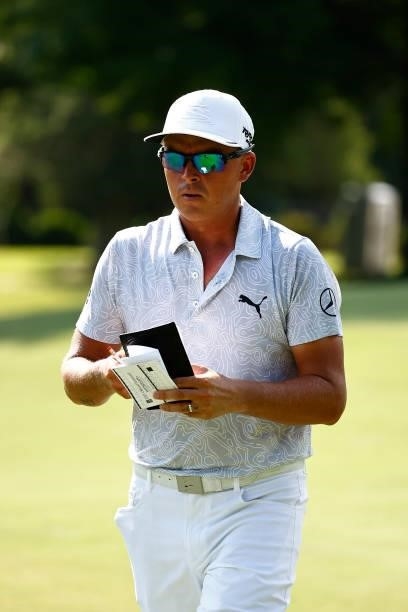 Rickie Fowler of the United States looks on from the 14th green during the first round of the Wyndham Championship at Sedgefield Country Club on...