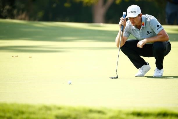 Justin Rose of England lines up a putt on the 14th green during the first round of the Wyndham Championship at Sedgefield Country Club on August 12,...