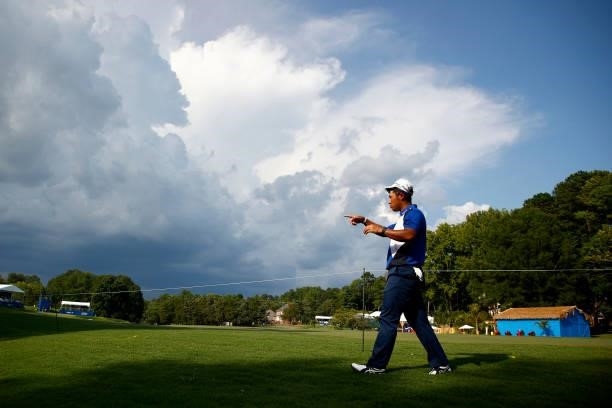 Hideki Matsuyama of Japan walks off the course during a weather delay due to inclement weather during the first round of the Wyndham Championship at...