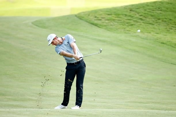 Justin Rose of England plays a second shot on the 14th hole during the first round of the Wyndham Championship at Sedgefield Country Club on August...