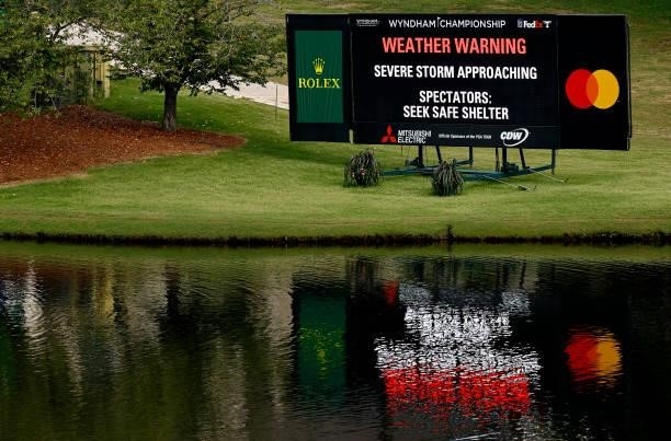 Sign on the 15th hole indicates that play has been suspended due to inclement weather during the first round of the Wyndham Championship at...
