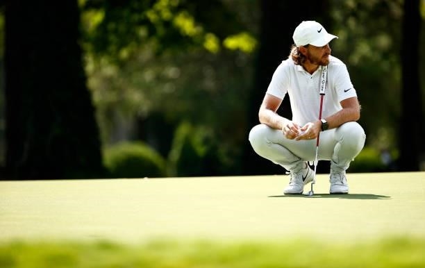 Tommy Fleetwood of England lines up a putt on the 14th green during the first round of the Wyndham Championship at Sedgefield Country Club on August...
