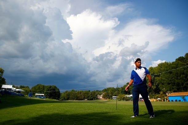 Hideki Matsuyama of Japan walks off the 15th hole due to inclement weather during the first round of the Wyndham Championship at Sedgefield Country...