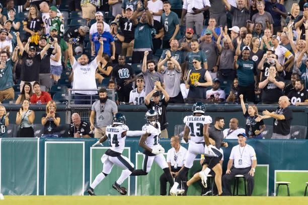 Quez Watkins of the Philadelphia Eagles celebrates with Kenneth Gainwell and Travis Fulgham after scoring a touchdown against the Pittsburgh Steelers...