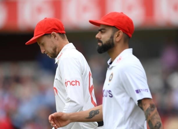 England captain Joe Root and India captain Virat Kohli take the field wearing their red caps on Ruth Strauss Foundation Day during day two of the...