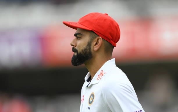 India captain Virat Kohli takes to the field wearing his red cap on Ruth Strauss Foundation Day during day two of the Second Test Match between...