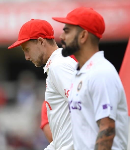 England captain Joe Root and India captain Virat Kohli take the field wearing their red caps on Ruth Strauss Foundation Day during day two of the...