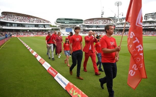 Former England captain Andrew Strauss walks round the outfield alongside families with have been supported by the Ruth Strauss Foundation ahead of...