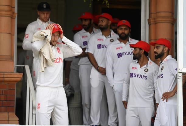 England captain Joe Root and India captain Virat Kohli wait on Red For Ruth caps to take to the field ahead of day two of the Second LV= Insurance...