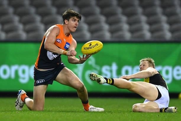 Sam Taylor of the Giants handballs during the round 22 AFL match between Greater Western Sydney Giants and Richmond Tigers at Marvel Stadium on...