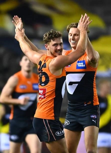 Harry Perryman of the Giants is congratulated by Lachie Whitfield after kicking a goal during the round 22 AFL match between Greater Western Sydney...