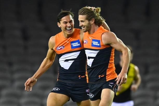 Callan Ward of the Giants is congratulated by Isaac Cumming after kicking a goal during the round 22 AFL match between Greater Western Sydney Giants...