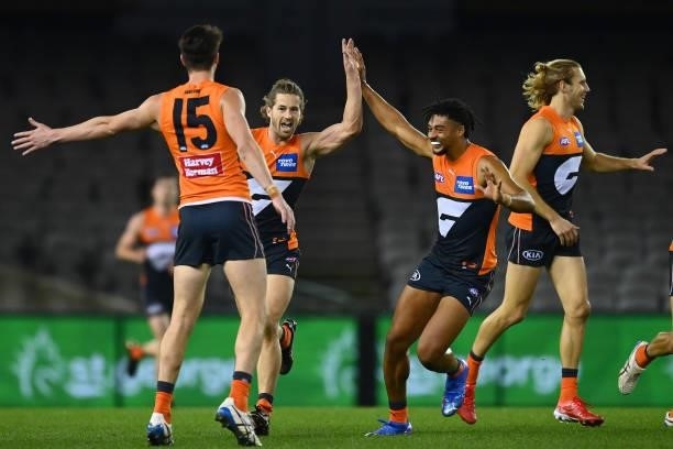 Callan Ward of the Giants is congratulated by team mates after kicking a goal during the round 22 AFL match between Greater Western Sydney Giants and...