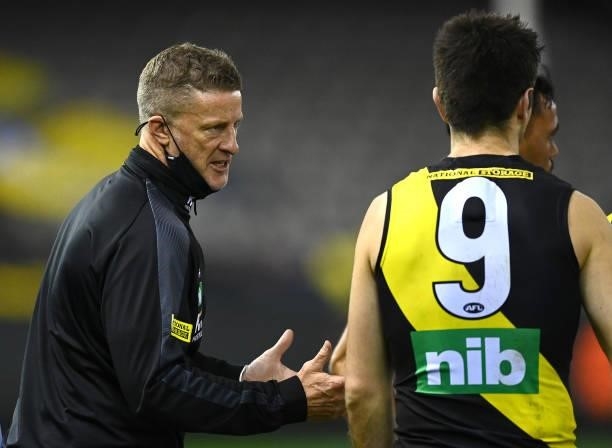 Tigers head coach Damien Hardwick talks to Trent Cotchin of the Tigers during the round 22 AFL match between Greater Western Sydney Giants and...