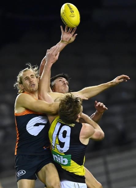 Nick Haynes and Sam Taylor of the Giants and Tom J. Lynch of the Tigers compete for a mark during the round 22 AFL match between Greater Western...